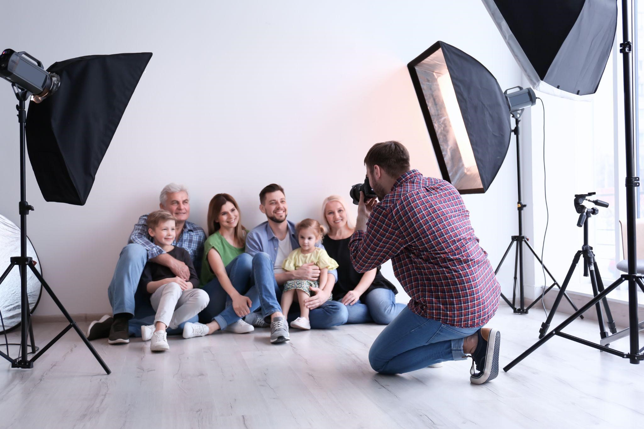 A photographer taking family photo in a studio.